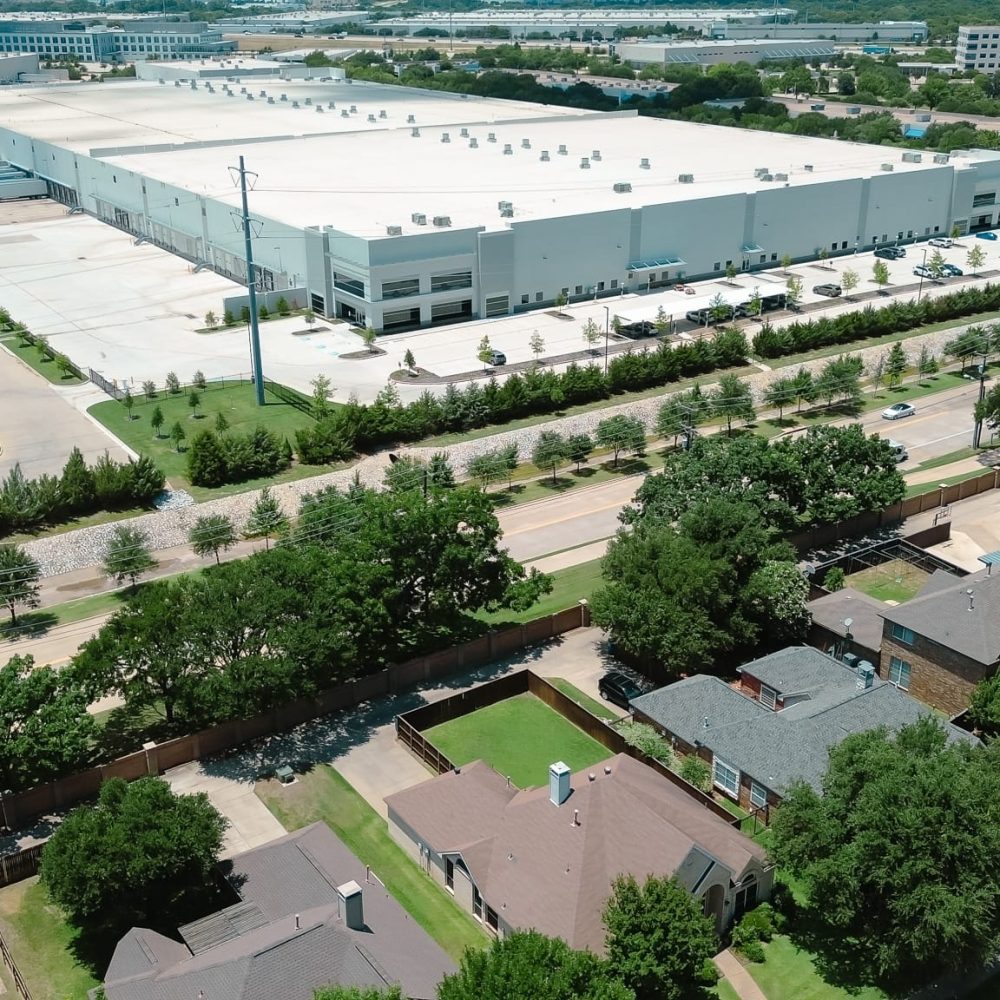 Suburban homes near large warehouses in Coppell, Dallas Fort Wor Suburban homes near large warehouses in Coppell, Dallas Fort Worth metroplex, growing hub for logistics, supply chain, distribution centers near DFW Airport, residential houses mixed-use zoning. USA