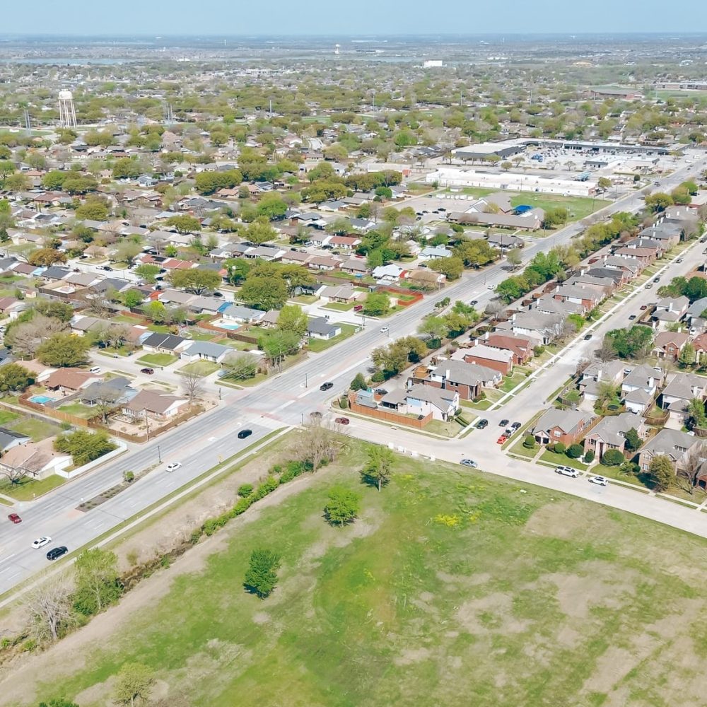 Vacant land near Worley and Memorial Drive fast growing suburban Vacant land near Worley and Memorial Drive fast growing suburban residential neighborhood in The Colony, Denton County, Texas, row of single-family houses in flat area by Lewisville Lake, aerial. USA
